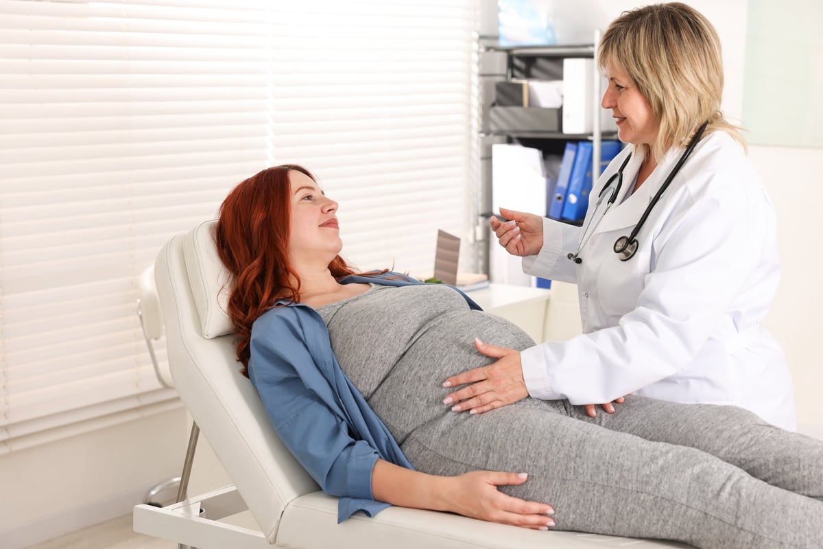 Pregnant woman having appointment with doctor in clinic
